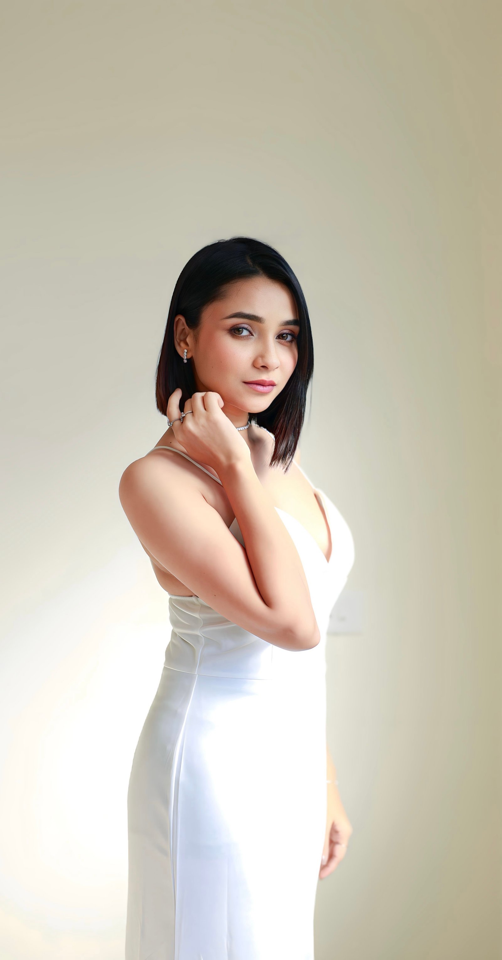 Hitakshi Chatterjee in an elegant white satin gown, studio portrait