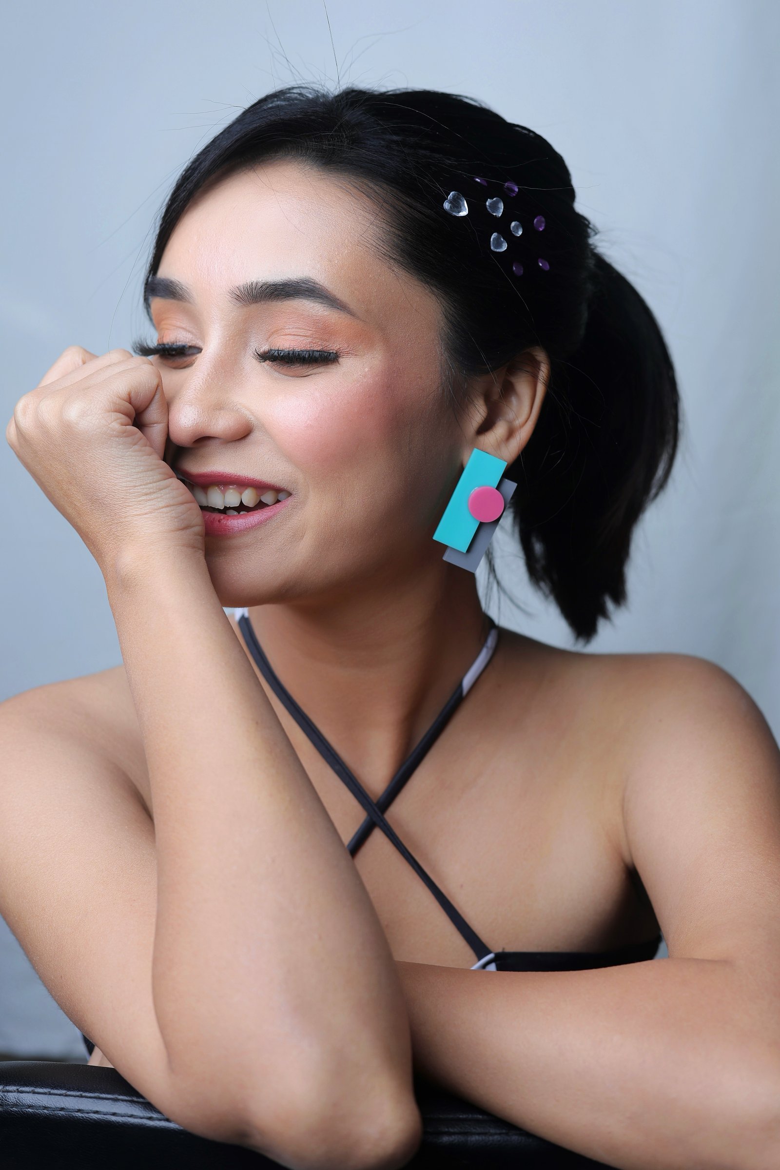 Hitakshi Chatterjee beauty close-up with graphic pastel earrings