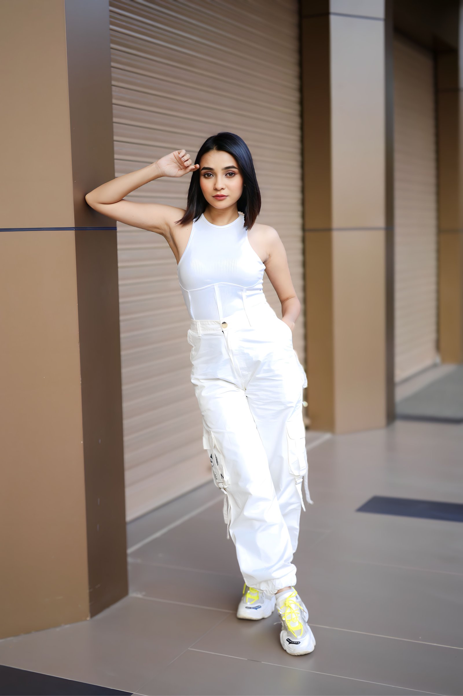 Hitakshi Chatterjee in an all-white top and cargo pants, street style