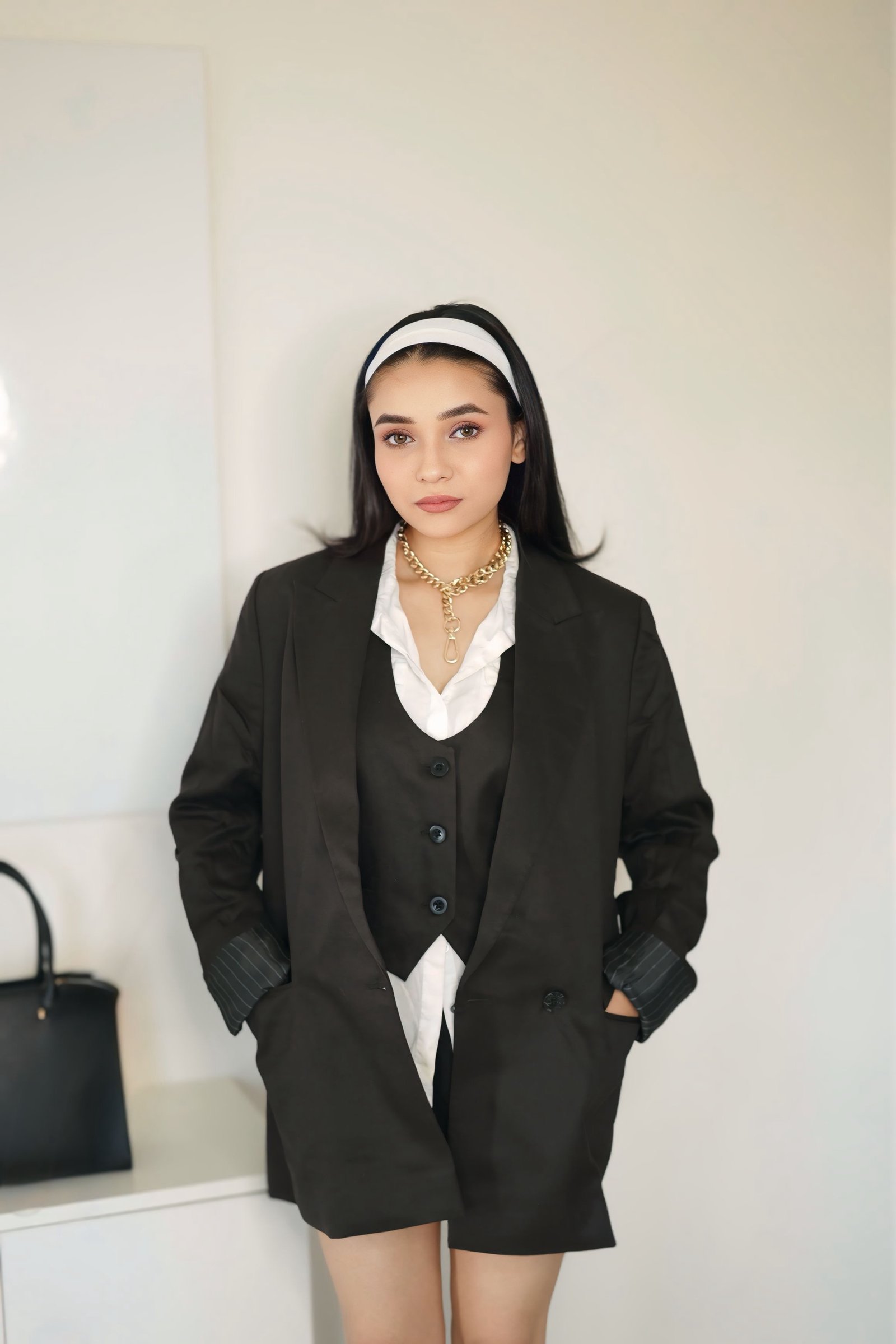 Hitakshi Chatterjee in an oversized black blazer and vest, minimal styling