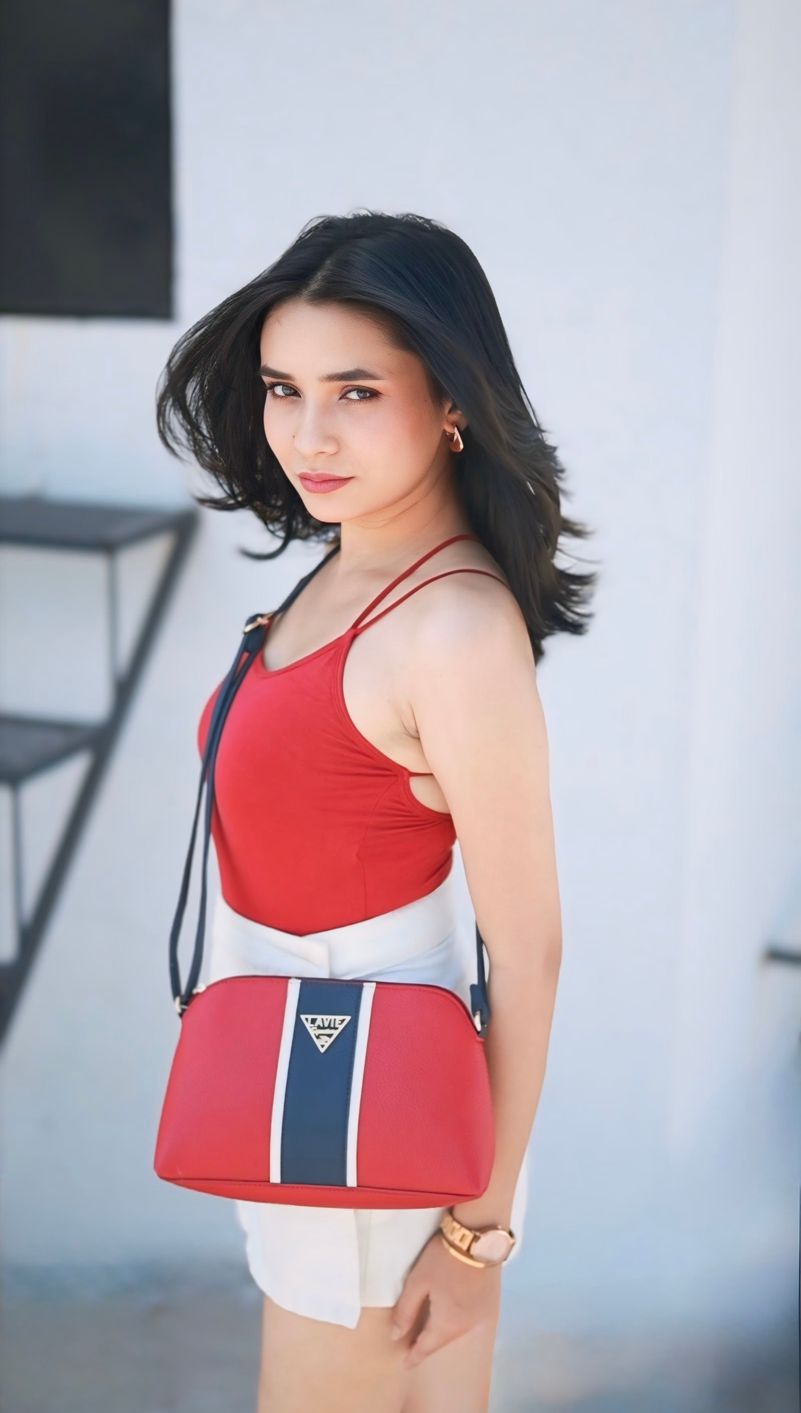 Hitakshi Chatterjee carrying a red and navy Lavie sling bag, brand collaboration shoot